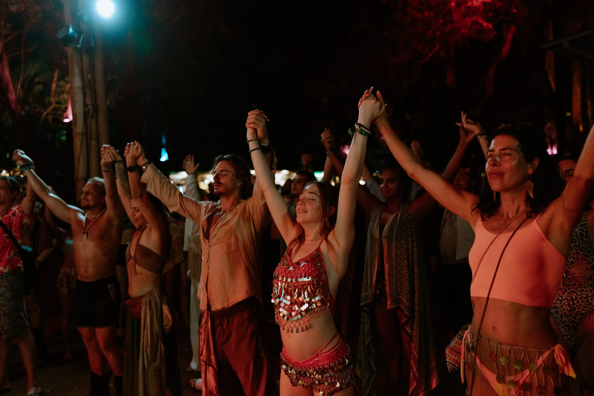 Hands raised, together, at a festival